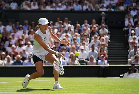 Iga Swiatek of Poland plays a volley against Taylor Townsend of the United States in their first round women's singles match at the Wimbledon Tennis Championships in London, Tuesday, June 30, 2026.