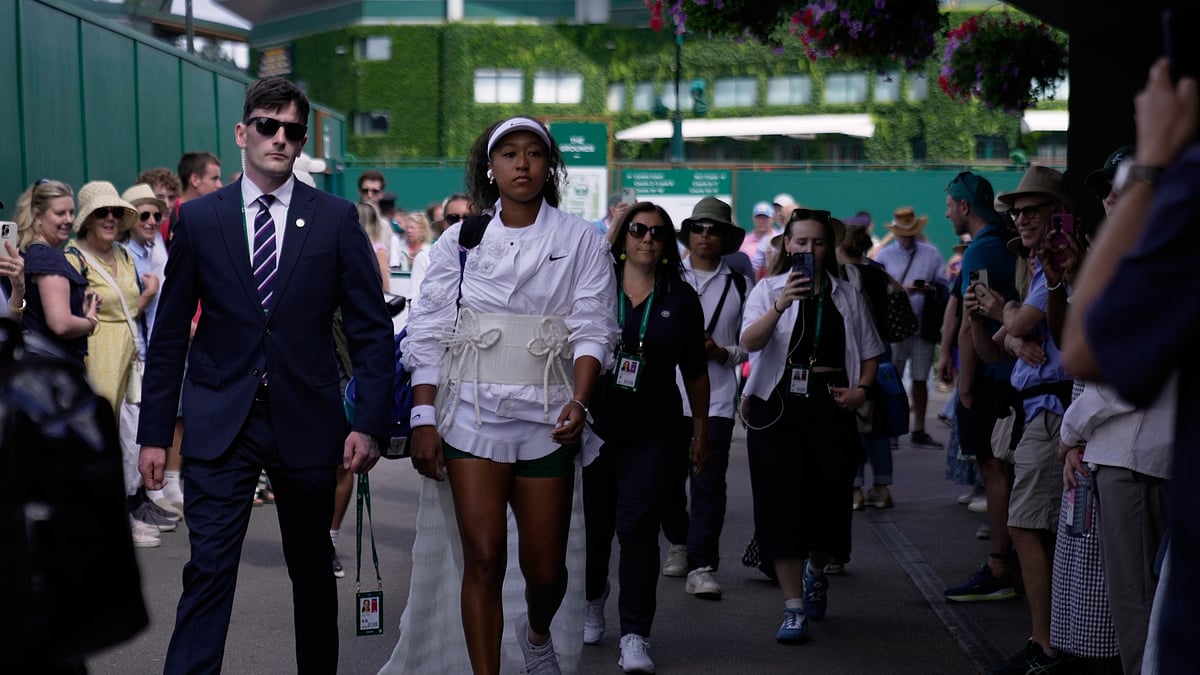 Naomi Osaka of Japan walks towards court 2 to play her second round women's singles match against Anastasia Gasanova of Russia, at the Wimbledon Tennis Championships in London, Wednesday, July 1, 2026. - (AP Photo/Brian Inganga)