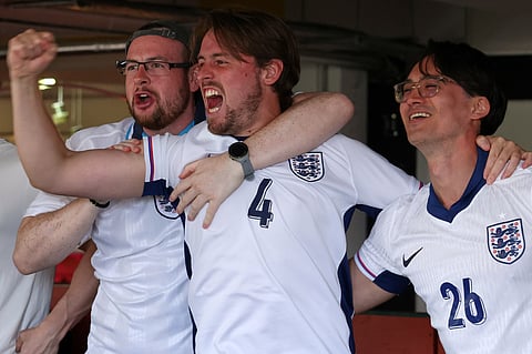 England soccer supporters cheer during the screening of the World Cup soccer match between England and DR Congo at the Multi Story in Peckham
