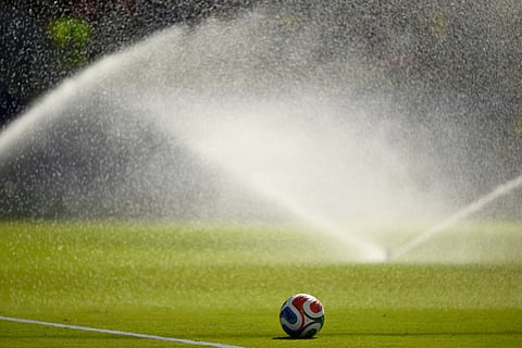 A soccer ball sits on the pitch as sprinklers water the field during a hydration break in the World Cup round of 32 soccer match between the United States and Bosnia in Santa Clara, Calif., near San Francisco, Wednesday, July 1, 2026