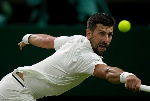 Novak Djokovic of Serbia returns the ball to Stefanos Tsitsipas of Greece in their second round men's singles match at the Wimbledon Tennis Championships in London, Wednesday, July 1, 2026.