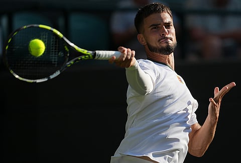 Dino Prizmic of Croatia plays a forehand against Felix Auger-Aliassime of Canada in their second round men's singles match at the Wimbledon Tennis Championships in London, Wednesday, July 1, 2026. 