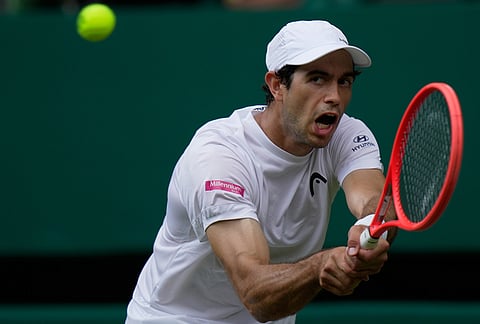 Nuno Borges of Portugal plays a backhand against Jannik Sinner of Italy in their second round men's singles match at the Wimbledon Tennis Championships in London, Wednesday, July 1, 2026. 