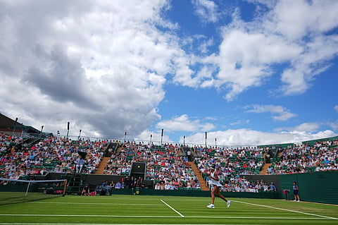 Naomi Osaka of Japan returns the ball during the second round women's singles match against Anastasia Gasanova of Russia at the Wimbledon Tennis Championships in London, Wednesday, July 1, 2026.