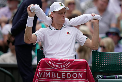 Jannik Sinner of Italy cools himself down after a game against Nuno Borges of Portugal in their second round men's singles match at the Wimbledon Tennis Championships in London, Wednesday, July 1, 2026. 