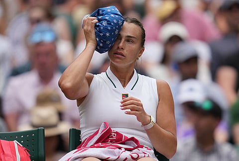 Aryna Sabalenka of Belarus uses ice to cool herself down during a changeover after a game against McCartney Kessler of the United States in their second round women's singles match at the Wimbledon Tennis Championships in London, Wednesday, July 1, 2026. 