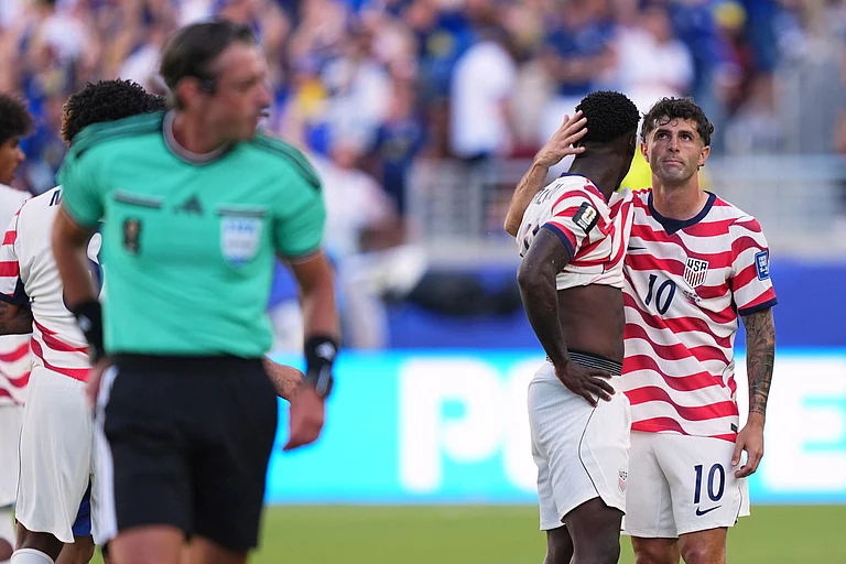United States' Folarin Balogun, center, gets a hug from United States' Christian Pulisic (10) after being issued a red card by Referee Raphael Claus, of Brazil, during the World Cup round of 32 soccer match between the United States and Bosnia in Santa Clara, Calif., near San Francisco, Wednesday, July 1, 2026 - (AP Photo/Martin Meissner)