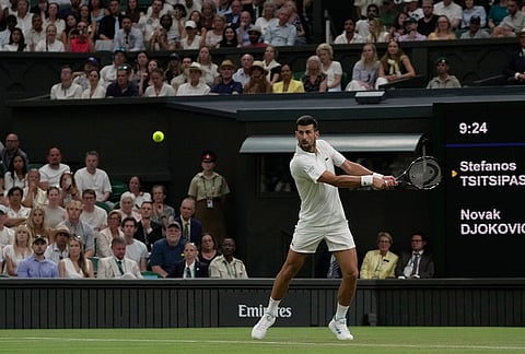 Novak Djokovic of Serbia returns the ball to Stefanos Tsitsipas of Greece in their second round men's singles match at the Wimbledon Tennis Championships in London, Wednesday, July 1, 2026. 