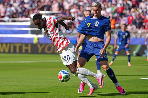 United States' Folarin Balogun (20) and Bosnia's Tarik Muharemovic (4) battle for the ball during the World Cup round of 32 soccer match between the United States and Bosnia in Santa Clara, Calif., near San Francisco, Wednesday, July 1, 2026