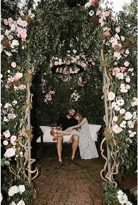 Their lovey-dovey pictures featured lush greenery, with pink and white flowers.