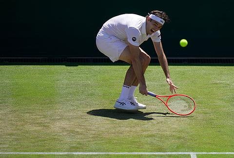 Taylor Fritz of the United States returns the ball to Patrick Kypson of the United States in their second round men's singles match at the Wimbledon Tennis Championships in London, Thursday, July 2, 2026.
