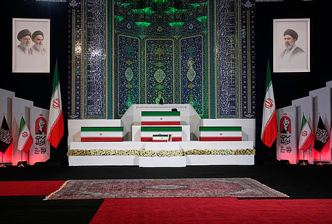 The coffins of slain Iranian Supreme Leader Ayatollah Ali Khamenei, center on top, and members of his family are displayed ahead of the dayslong funeral ceremonies at the Imam Khomeini Mosalla Grand Mosque in Tehran, Iran.