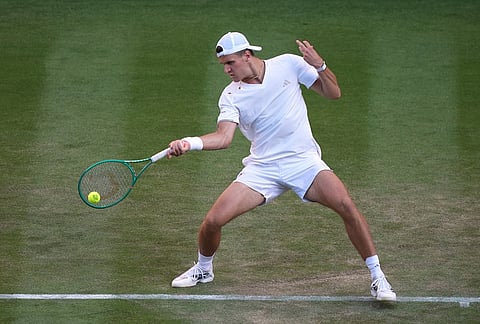 Jakub Mensik of Czech Republic returns the ball to Grigor Dimitrov of Bulgaria in their second round men's singles match at the Wimbledon Tennis Championships in London, Thursday, July 2, 2026. 