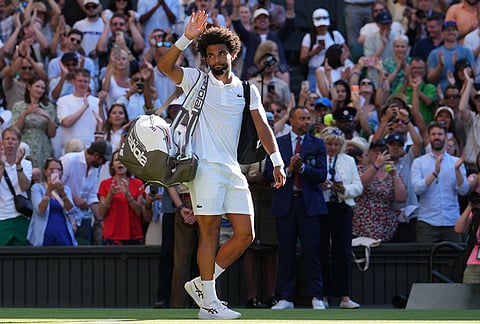 Arthur Fils of France waves to the crowd after losing the second round men's singles match against Matteo Berrettini of Italy at the Wimbledon Tennis Championships in London, Thursday, July 2, 2026.