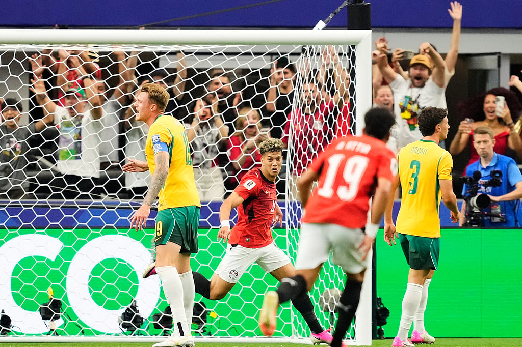 Egypts Emam Ashour, center, celebrates scoring his sides opening goal against Australia during the World Cup round of 32 soccer match in Arlington