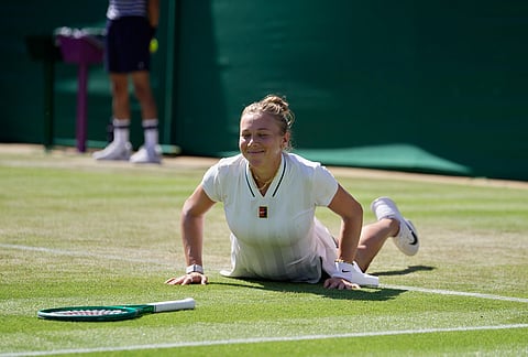Amanda Anisimova of the United States gets up after falling down during a point against Sofia Kenin of the United States in their second round women's singles match at the Wimbledon Tennis Championships in London, Thursday, July 2, 2026.