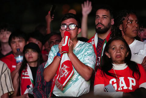 Fans watching on a big screen in Lisbon, Portugal, react during the World Cup round of 32 soccer match between Portugal and Croatia, Friday, July 3, 2026.