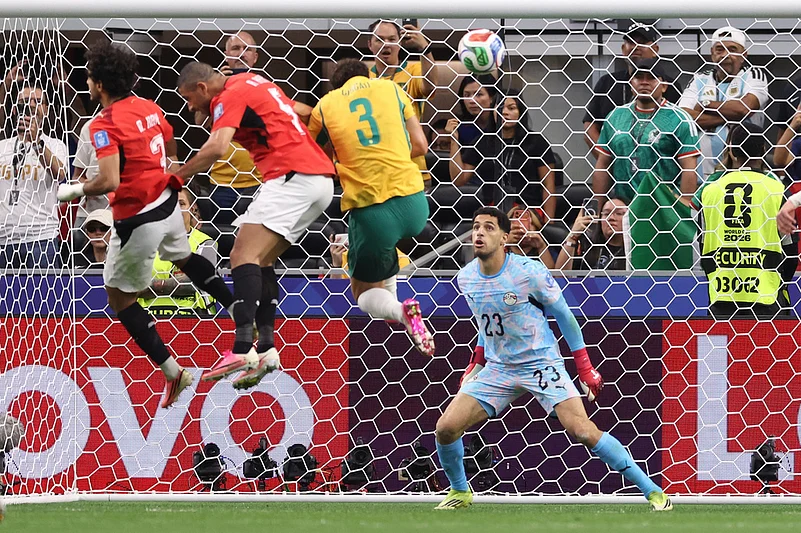 Egypt goalkeeper Mostafa Shoubir (23) looks at the ball as Egypts Mohamed Hany, left, scores an own goal during the World Cup round of 32 soccer match between Australia and Egypt in Arlington