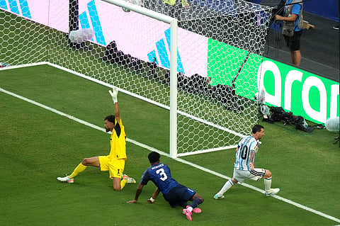 Argentina's Lionel Messi (10) scores their first goal against Cape Verde goalkeeper Vozinha (1) and Diney Borges (3) during the World Cup round of 32 soccer match between Argentina and Cape Verde in Miami Gardens