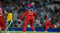 England's Sophie Ecclestone, back to the camera, celebrates with Linsey Smith, top, after winning the Women's T20 Cricket World Cup semifinal match between England and South Africa in London, Thursday, July 2, 2026 - (AP Photo/Alastair Grant)