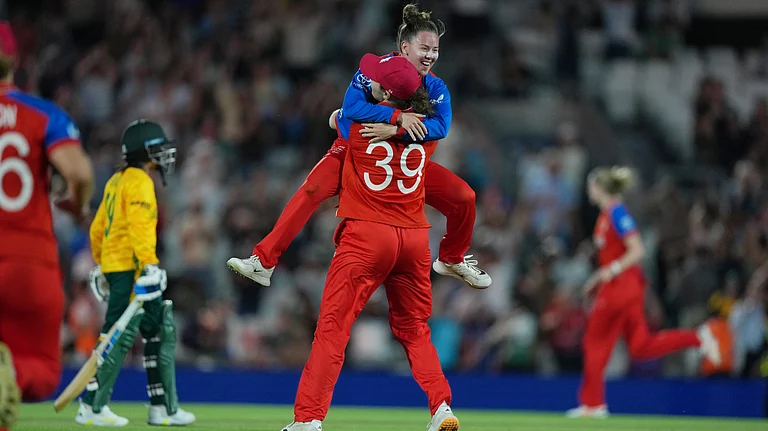 England's Sophie Ecclestone, back to the camera, celebrates with Linsey Smith, top, after winning the Women's T20 Cricket World Cup semifinal match between England and South Africa in London, Thursday, July 2, 2026 - (AP Photo/Alastair Grant)