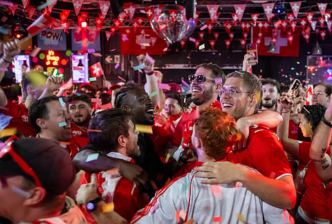 Swiss supporters react at a public viewing of the World Cup round of 32 soccer match between Switzerland and Algeria, in the fan zone "Village su Soir" in Geneva, Switzerland, Friday, July 3, 2026.