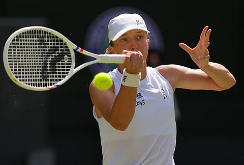 Iga Swiatek of Poland returns the ball during the second round women's singles match against Karolina Pliskova of the Czech Republic at the Wimbledon Tennis Championships in London, Thursday, July 2, 2026.