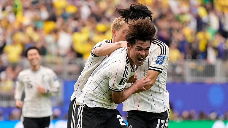 Japan's Kaishu Sano (24) celebrates after scoring the opening goal of his team during the World Cup round of 32 soccer match between Brazil and Japan in Houston, Monday, June 29, 2026. - (AP Photo/Ashley Landis)