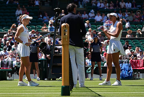 Katie Swan of Britain, left, and Madison Keys of the United States speak with the umpire at the net at the beginning of their second round women's singles match at the Wimbledon Tennis Championships in London, Thursday, July 2, 2026.
