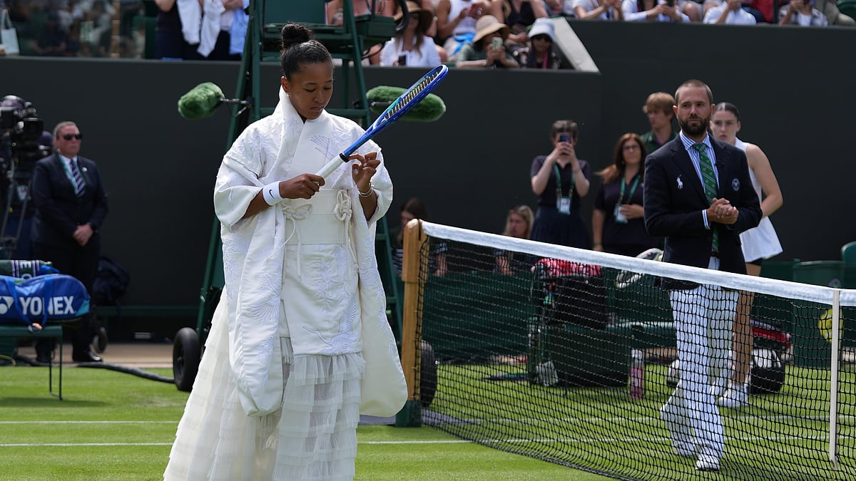 Naomi Osaka of Japan walks into the court to play against Elsa Jacquemot of France in their first round women's singles match at the Wimbledon Tennis Championships in London, Monday, June 29, 2026. - (AP Photo/Maja Smiejkowska)
