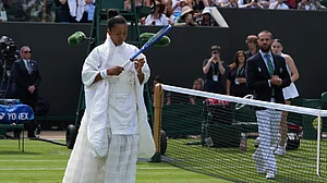 (AP Photo/Maja Smiejkowska) : Naomi Osaka of Japan walks into the court to play against Elsa Jacquemot of France in their first round women's singles match at the Wimbledon Tennis Championships in London, Monday, June 29, 2026.