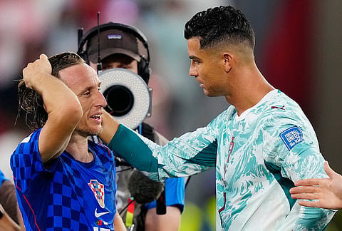 Croatia's Luka Modric (10) and Portugal's Cristiano Ronaldo (7) greet each other after the World Cup round of 32 soccer match between Portugal and Croatia in Toronto. 