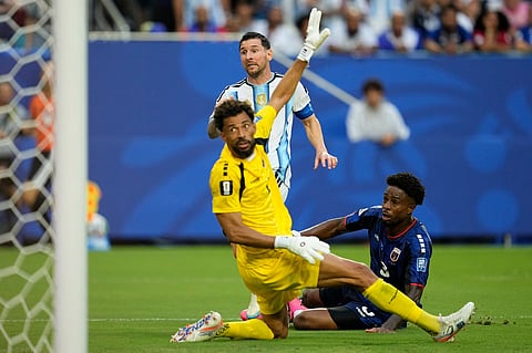 Argentina's Lionel Messi (10) scores their first goal against Cape Verde goalkeeper Vozinha (1) during the World Cup round of 32 soccer match between Argentina and Cape Verde in Miami Gardens