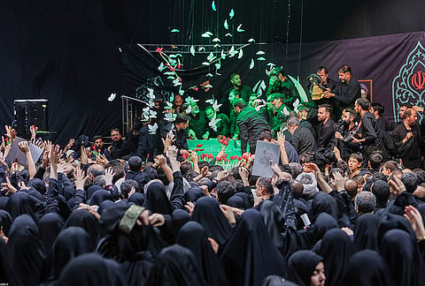 Mourners gather around the coffin of Iran's Supreme Leader Ayatollah Ali Khamenei as it lies in a mourning hall adjacent to the Imam Khomeini Hussainiya within the Supreme Leader's compound before his funeral in Tehran, Iran.