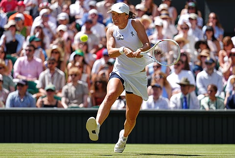 Iga Swiatek of Poland returns the ball during the second round women's singles match against Karolina Pliskova of the Czech Republic at the Wimbledon Tennis Championships in London, Thursday, July 2, 2026.