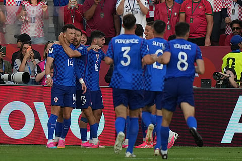 Croatia's Ivan Perisic (14) is congratulated by his teammates after scoring his side's first goal against Portugal during the World Cup round of 32 soccer match in Toronto, Thursday, July 2, 2026.