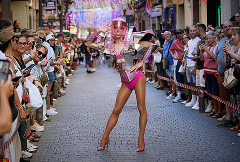 A participant wearing shoes with heels of at least 10 centimeters (3.9 inches) poses in the annual high heel race during Madrid's Pride week, in Madrid. 