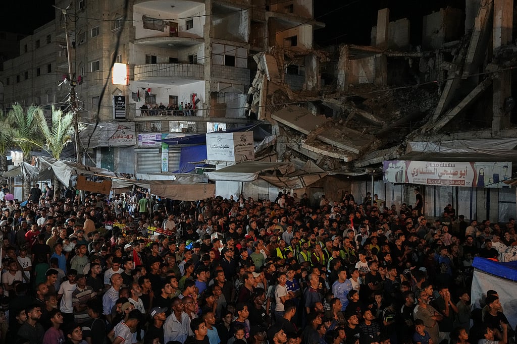 Palestinians watch a live broadcast of the World Cup round of 32 soccer match between Egypt and Australia in Nuseirat