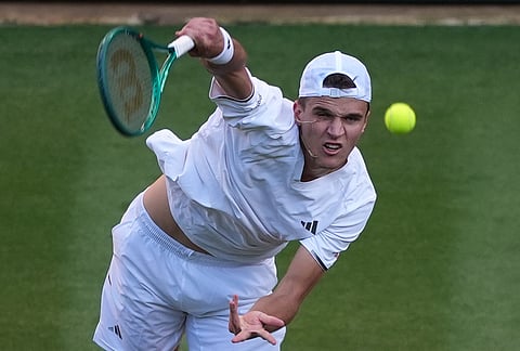 Jakub Mensik of Czech Republic serves against Grigor Dimitrov of Bulgaria in their second round men's singles match at the Wimbledon Tennis Championships in London, Thursday, July 2, 2026. 