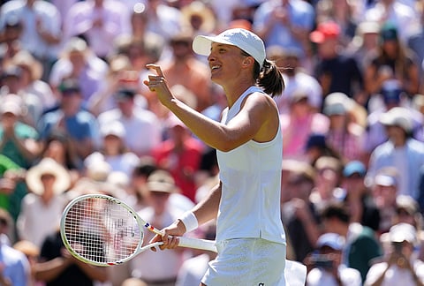 Iga Swiatek of Poland celebrates winning the second round women's singles match against Karolina Pliskova of the Czech Republic at the Wimbledon Tennis Championships in London, Thursday, July 2, 2026.