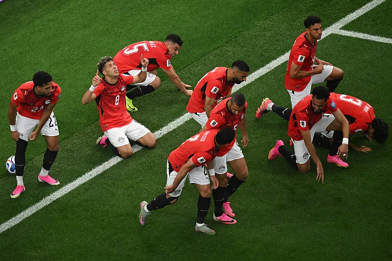 Egypt players bow in prayer after scoring opening goal during the World Cup round of 32 soccer match between Australia and Egypt in Arlington