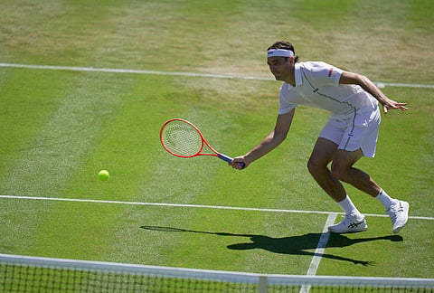 Taylor Fritz of the United States returns the ball to Patrick Kypson of the United States in their second round men's singles match at the Wimbledon Tennis Championships in London, Thursday, July 2, 2026. 