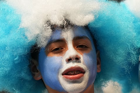 A fan of Argentina waits for the beginning of the World Cup round of 32 soccer match against Cape Verde in Miami Gardens