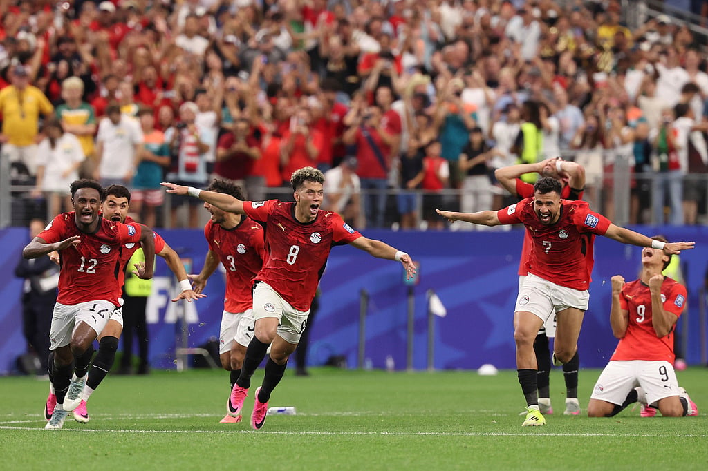 Egypts players celebrate after their teammate Hossam Abdelmaguid (4) score the winning penalty during World Cup round of 32 soccer match between Australia and Egypt in Arlington