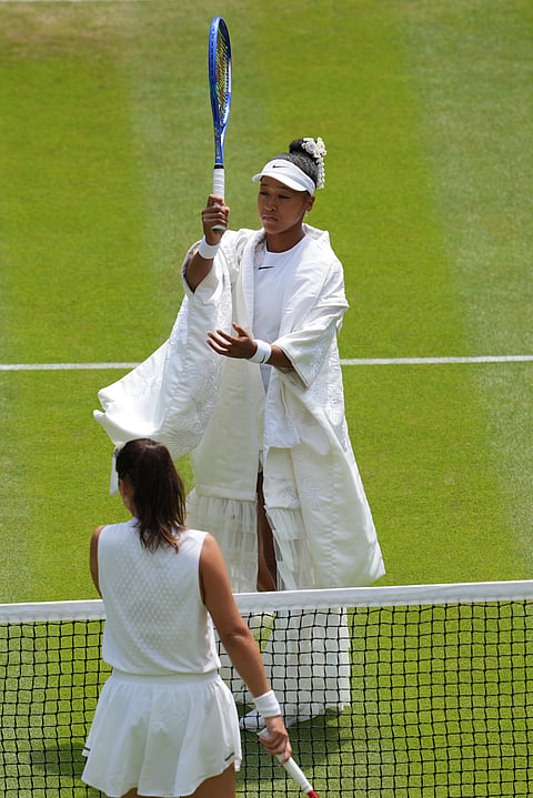 Naomi Osaka of Japan, top, warms up with her racket in front of her rival Daria Kasatkina of Australia, ahead of their third round women's singles match at the Wimbledon Tennis Championships in London, Friday, July 3, 2026.