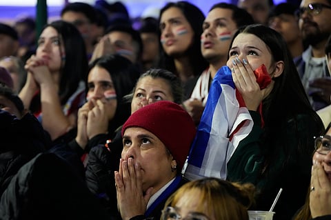 Fans watch the World Cup round of 16 soccer match between Paraguay and France in Asuncion, Paraguay