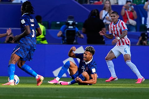 France's Desire Doue falls during the World Cup round of 16 soccer match against Paraguay in Philadelphia