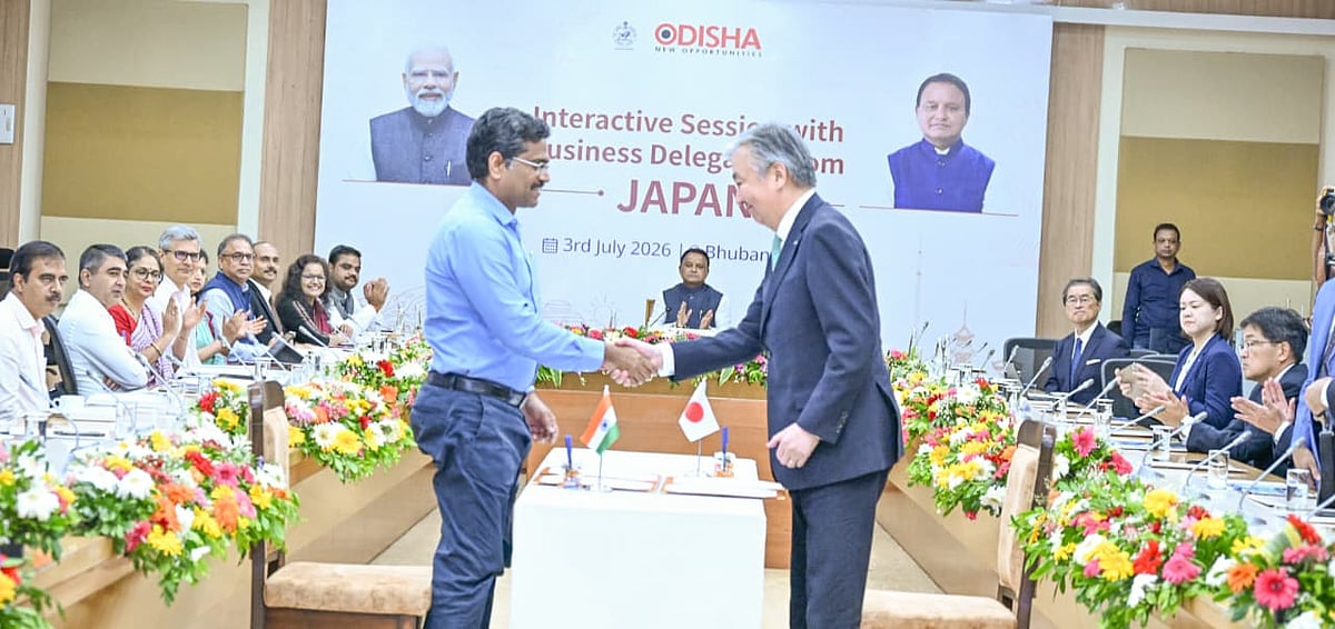 Officials from Odisha and Japan shake hands at a business interaction event