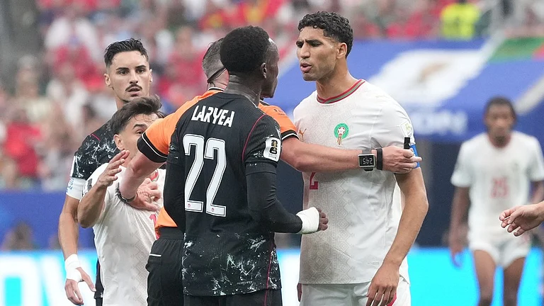 Canada's Richie Laryea, left, and Morocco's Achraf Hakimi argue during the World Cup round of 16 soccer match between Canada and Morocco in Houston - Eric Gay/AP Photo