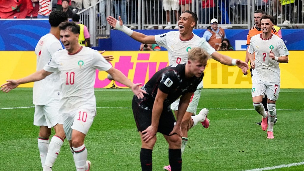 Morocco's Soufiane Rahimi, back, celebrates after scoring his side's third goal against Canada during the World Cup round of 16 soccer match in Houston. - David J. Phillip/AP Photo